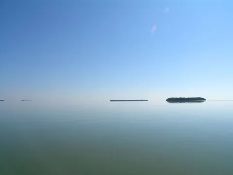 Low wooded islands above reflective water in Florida Bay.